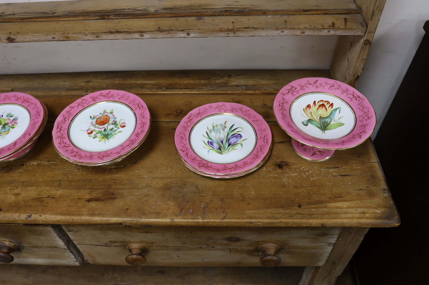 An English porcelain pink ground floral dessert service, late 19th century